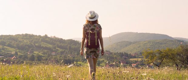 Traveler Girl Walking Through Fields. Young Girl Traveler Walkin