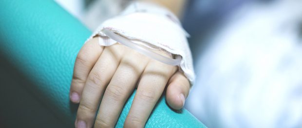 A Hand With Sick Child On A Receiving A Saline Solution In Hospi